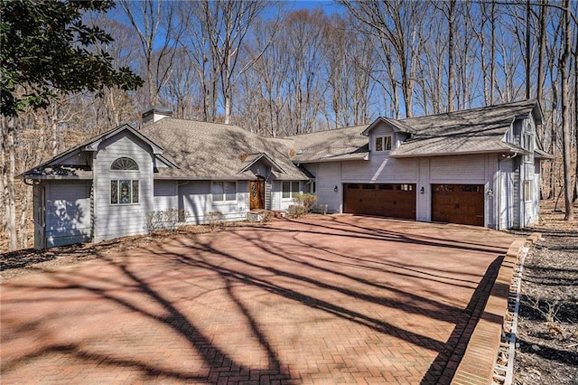 view of front of home featuring decorative driveway and an attached garage