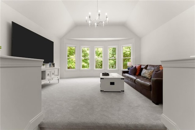 carpeted living area featuring a chandelier and vaulted ceiling