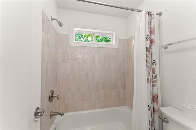 bathroom with toilet and shower / bath combo