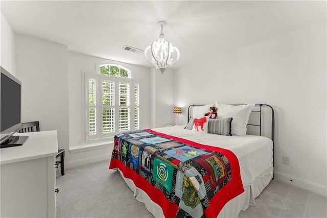 carpeted bedroom with a chandelier and baseboards