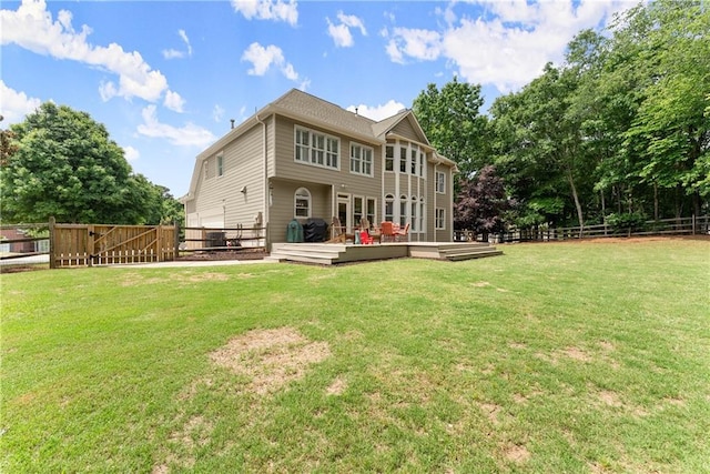 rear view of property featuring a deck