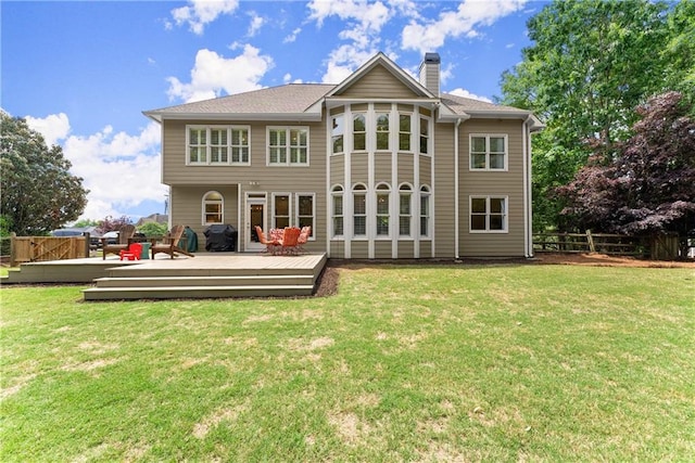 rear view of property with a chimney and a wooden deck