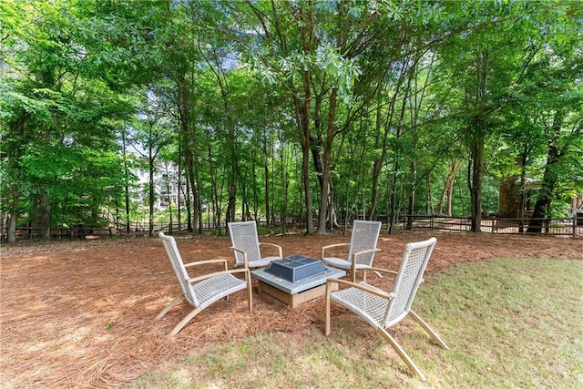 view of yard featuring fence and an outdoor fire pit