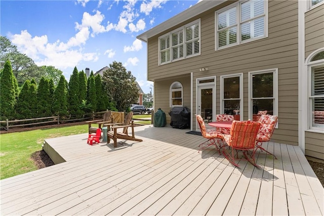 wooden deck featuring outdoor dining space and area for grilling
