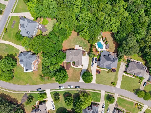 aerial overview of property's location featuring a pool and nearby suburban area