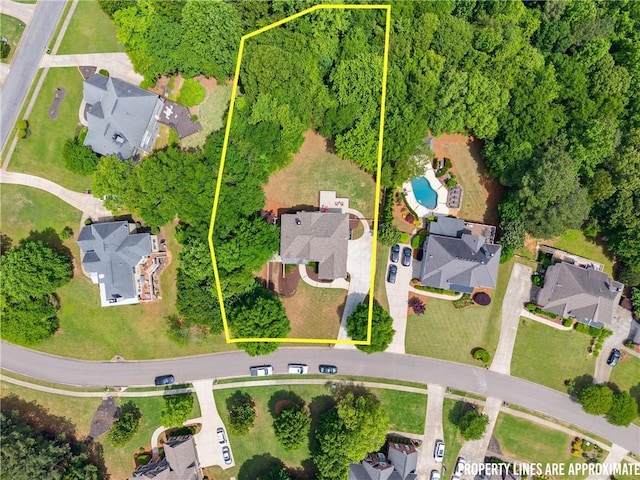 aerial perspective of suburban area featuring a pool and property parcel outlined