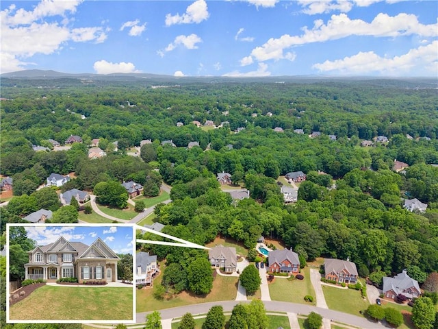 aerial view of property's location featuring a heavily wooded area and property parcel outlined