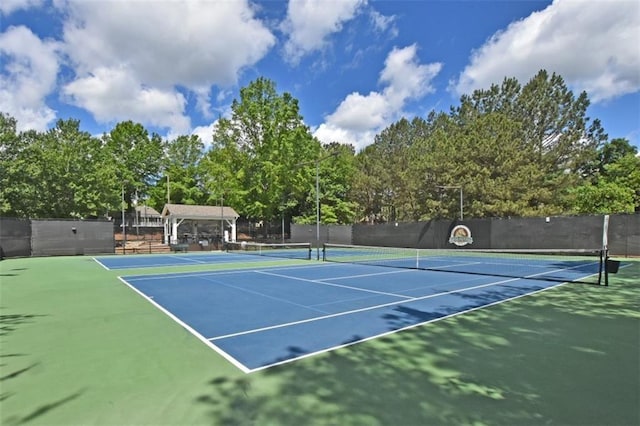 view of tennis court featuring fence and community basketball court
