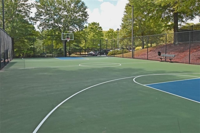 view of basketball court featuring fence and community basketball court