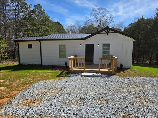 4064 Post Rd, Winston, GA 30187 - back of property with a wooden deck, a metal roof, a standing seam roof, and a yard