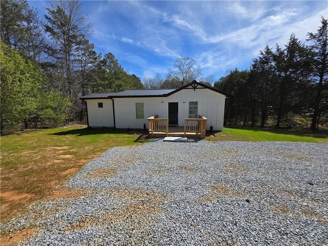 4064 Post Rd, Winston, GA 30187 - back of property featuring a yard, a wooden deck, gravel driveway, and metal roof