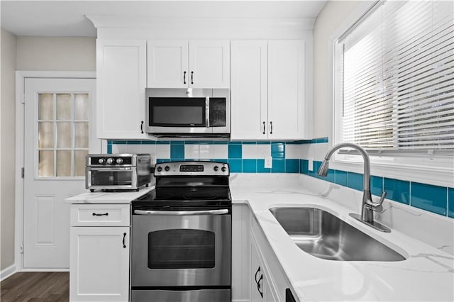 4064 Post Rd, Winston, GA 30187 - kitchen featuring stainless steel appliances, white cabinets, and light stone countertops