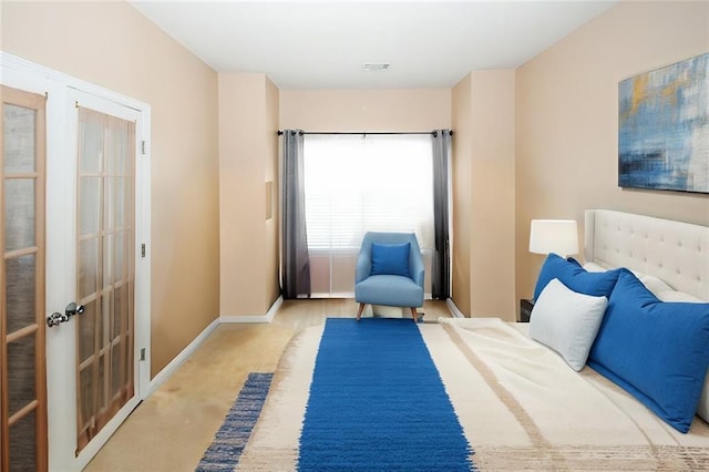 carpeted bedroom with french doors