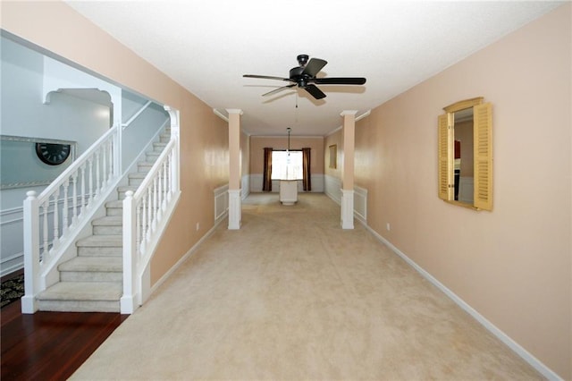 hallway with decorative columns and carpet