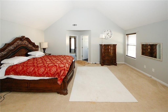 carpeted bedroom with lofted ceiling