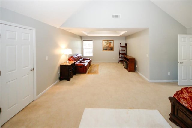 living area with light colored carpet and lofted ceiling