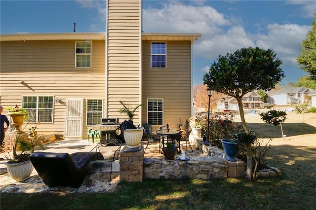 rear view of property featuring a patio area