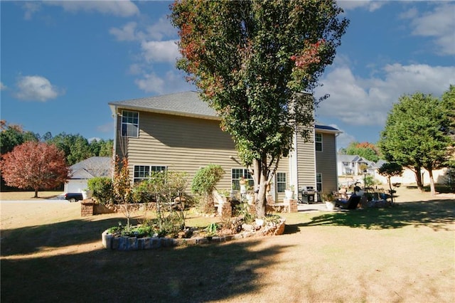 rear view of house with a yard