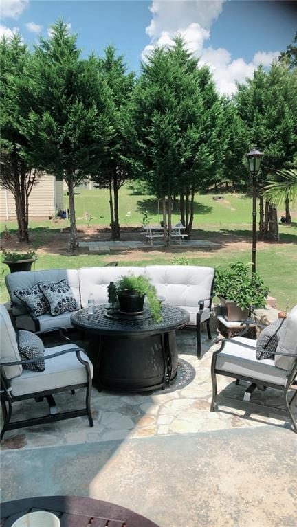 view of property's community featuring a yard, a patio area, and outdoor lounge area