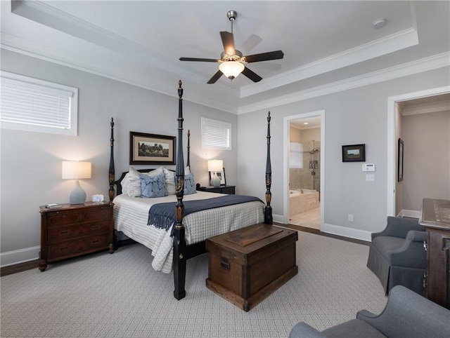 bedroom featuring crown molding, ceiling fan, connected bathroom, and a raised ceiling