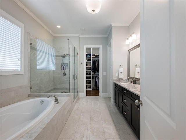 bathroom with crown molding, vanity, and separate shower and tub