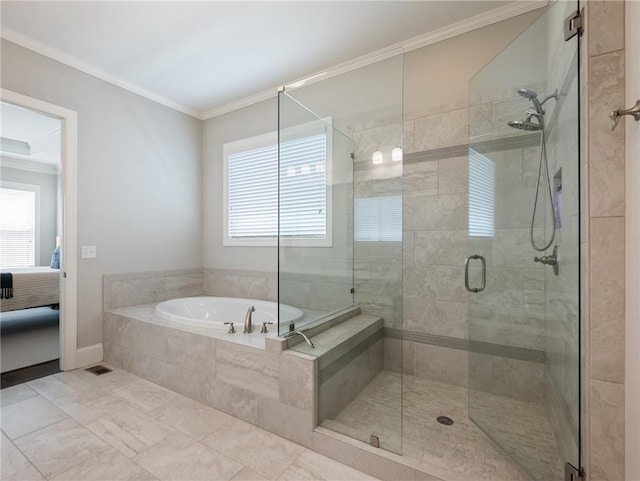 bathroom with ornamental molding and separate shower and tub