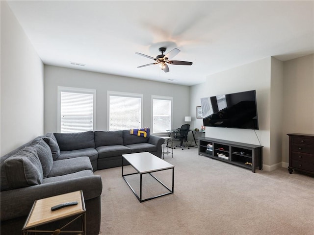 carpeted living room with ceiling fan