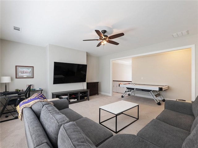 carpeted living room featuring ceiling fan