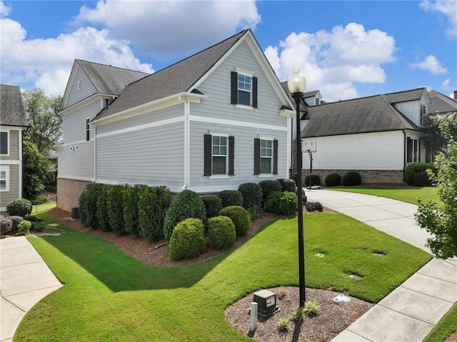 view of side of home with a lawn