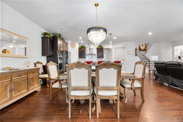 dining space featuring dark hardwood / wood-style flooring and a notable chandelier