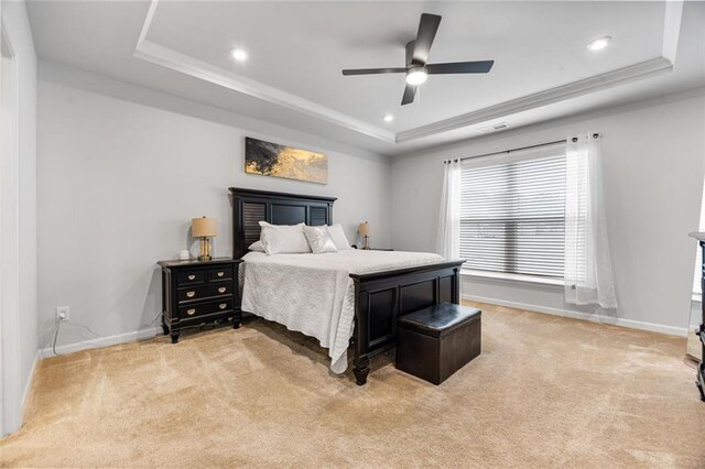 bedroom featuring a raised ceiling, carpet flooring, and ceiling fan