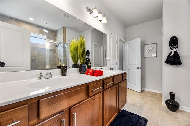 bathroom featuring an enclosed shower, vanity, and tile patterned floors