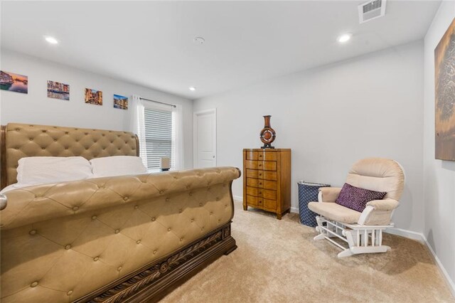 bedroom featuring light colored carpet