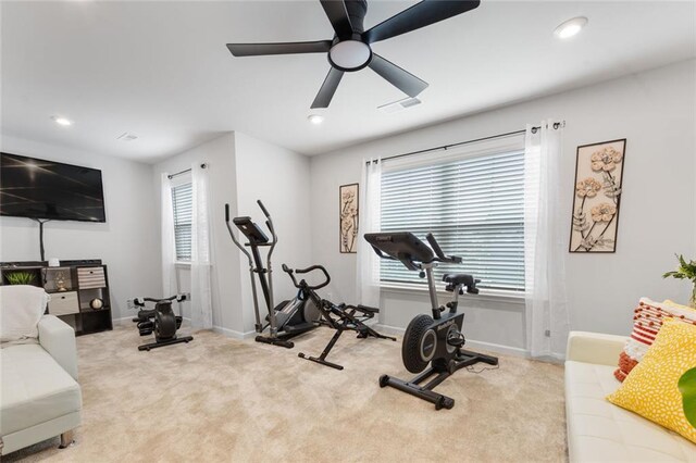 workout area with light colored carpet and ceiling fan