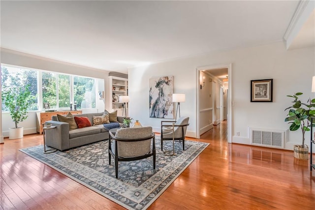 living room featuring crown molding and wood-type flooring