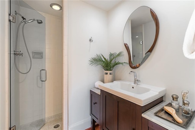 bathroom featuring vanity and an enclosed shower