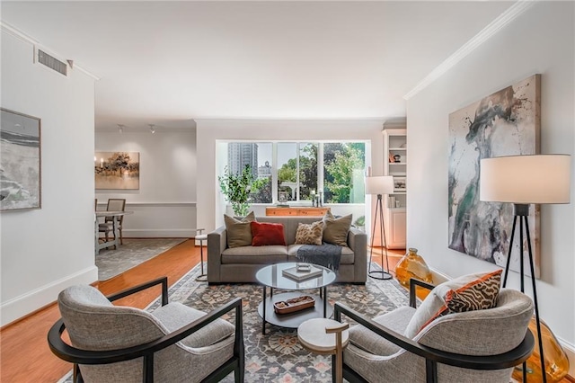 living room with hardwood / wood-style flooring and ornamental molding