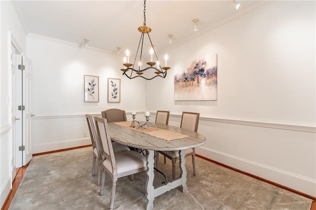 dining area with crown molding, hardwood / wood-style floors, and a chandelier