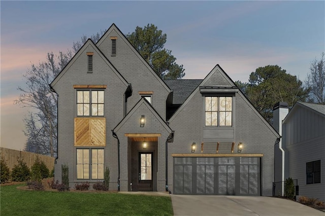 view of front facade featuring a garage and a yard