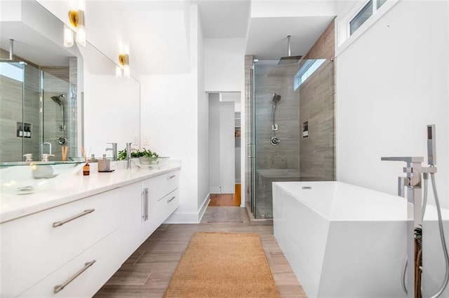 167 Sampson St NE, Atlanta, GA 30312 - full bath featuring a shower stall, vanity, a soaking tub, and wood finished floors