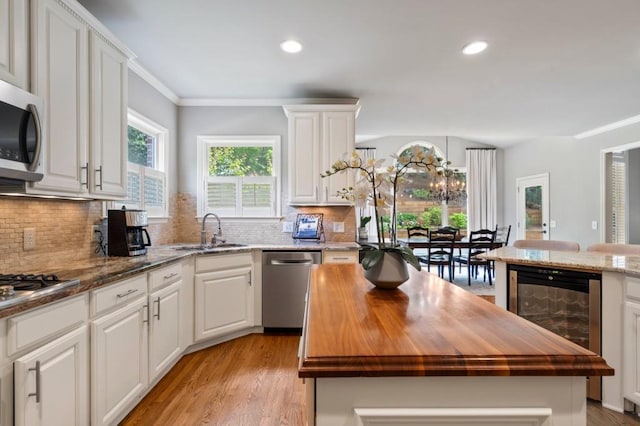4250 Old Oak Trce, Cumming, GA 30041 - kitchen featuring wine cooler, a sink, appliances with stainless steel finishes, wood counters, and recessed lighting