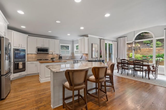 4250 Old Oak Trce, Cumming, GA 30041 - kitchen with stainless steel appliances, white cabinets, tasteful backsplash, light wood finished floors, and recessed lighting