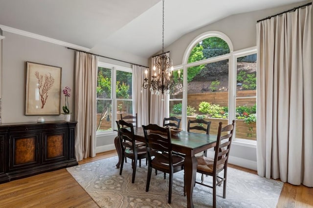 4250 Old Oak Trce, Cumming, GA 30041 - dining area featuring a chandelier, lofted ceiling, plenty of natural light, light wood-style floors, and baseboards