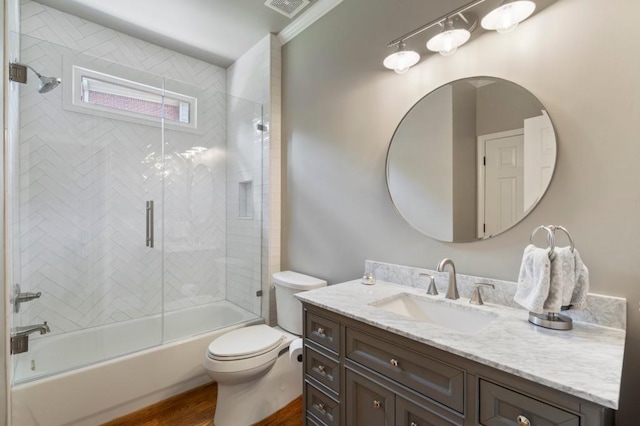 4250 Old Oak Trce, Cumming, GA 30041 - bathroom featuring toilet, wood finished floors, vanity, and shower / bath combination with glass door
