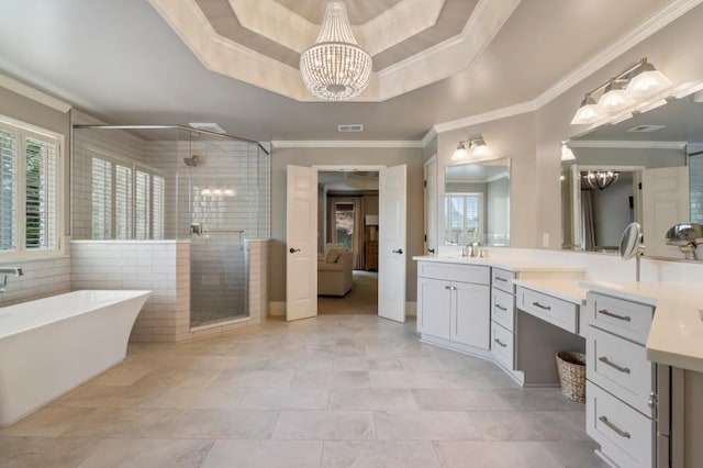 4250 Old Oak Trce, Cumming, GA 30041 - bathroom featuring a chandelier, a shower stall, a freestanding tub, vanity, and crown molding