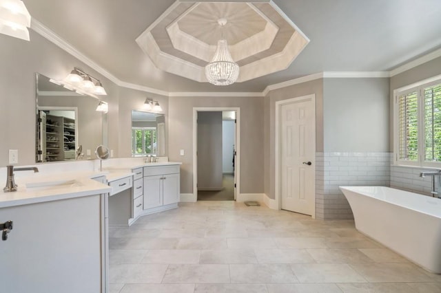 4250 Old Oak Trce, Cumming, GA 30041 - full bath with a raised ceiling, a soaking tub, vanity, a chandelier, and ornamental molding