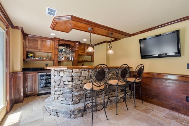 4250 Old Oak Trce, Cumming, GA 30041 - indoor bar featuring wine cooler, stone tile floors, crown molding, recessed lighting, and hanging light fixtures