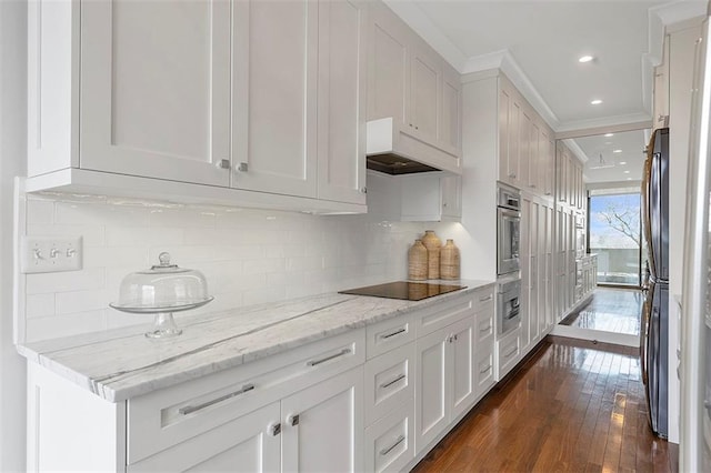 2575 Peachtree Rd NE Unit 11D, Atlanta, GA 30305 - kitchen featuring white cabinetry, appliances with stainless steel finishes, dark wood-type flooring, and light stone counters