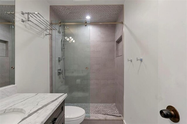 2575 Peachtree Rd NE Unit 11D, Atlanta, GA 30305 - bathroom featuring vanity, toilet, and a shower with shower door