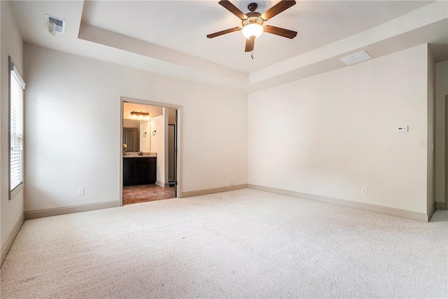 3175 Rock Port Cir, Norcross, GA 30092 - empty room with plenty of natural light, light carpet, a ceiling fan, and a raised ceiling